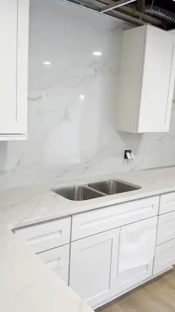 White counters and slab backsplash, install day