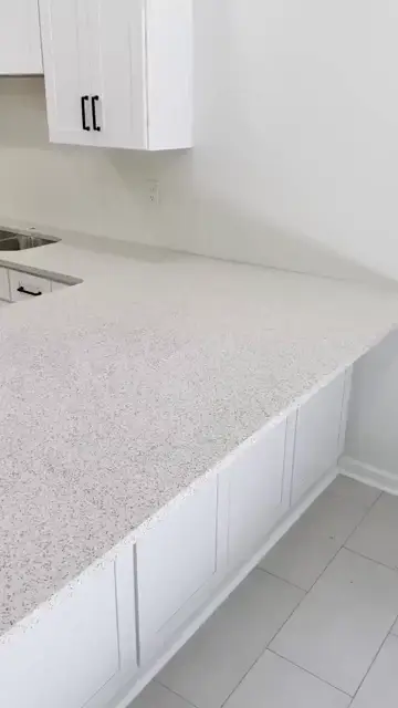 Speckled white countertops in a finished kitchen