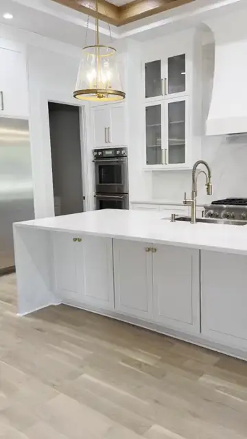 Long white island and range wall in a finished kitchen