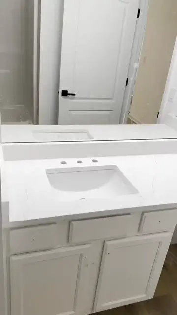 Long white vanity top with a makeup counter