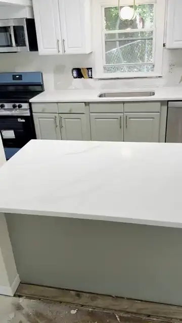 White island and perimeter over sage cabinets