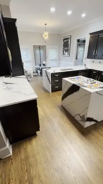 Black cabinet kitchen with a waterfall island