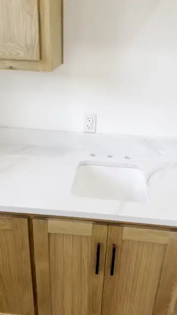 White vanity top over oak cabinets